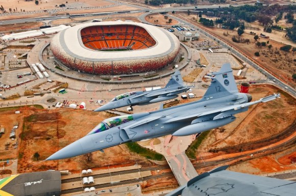[Internacional] Com cortes orçamentários ‘até o osso’, África do Sul armazena 12 caças Gripen Gripens-da-SAAF-sobre-estádio-em-Johannesburg-foto-SAAB-580x385