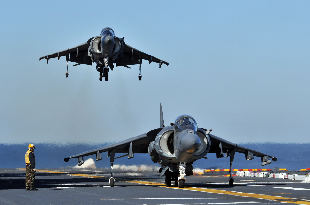 Two AV-8B Harriers from Marine Attack Squadron (VMA) 542 conduct flight operations aboard the amphibious assault ship USS Kearsarge (LHD 3)