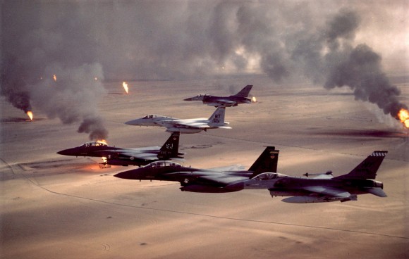 F-16A Fighting Falcons and F-15C and F-15E Eagles fly over burning oil fields during Desert Storm. Operation Desert Storm began Jan. 17, 1991.